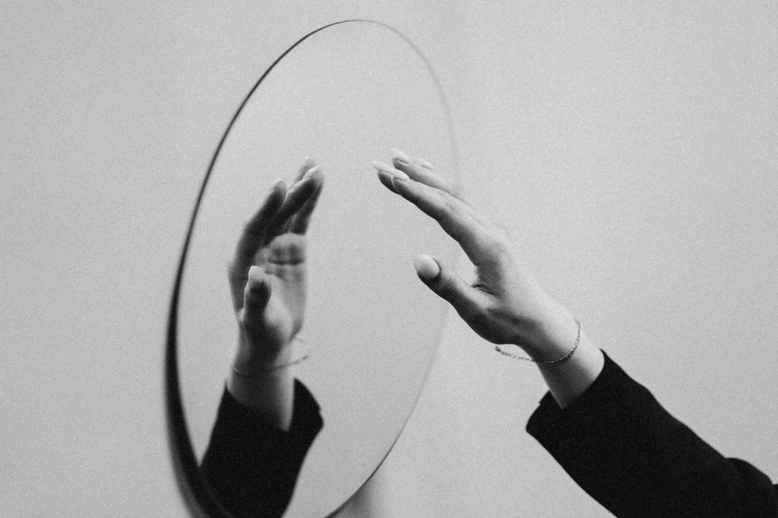 stop avoiding problems picture of a mirror and a hand reaching the mirror