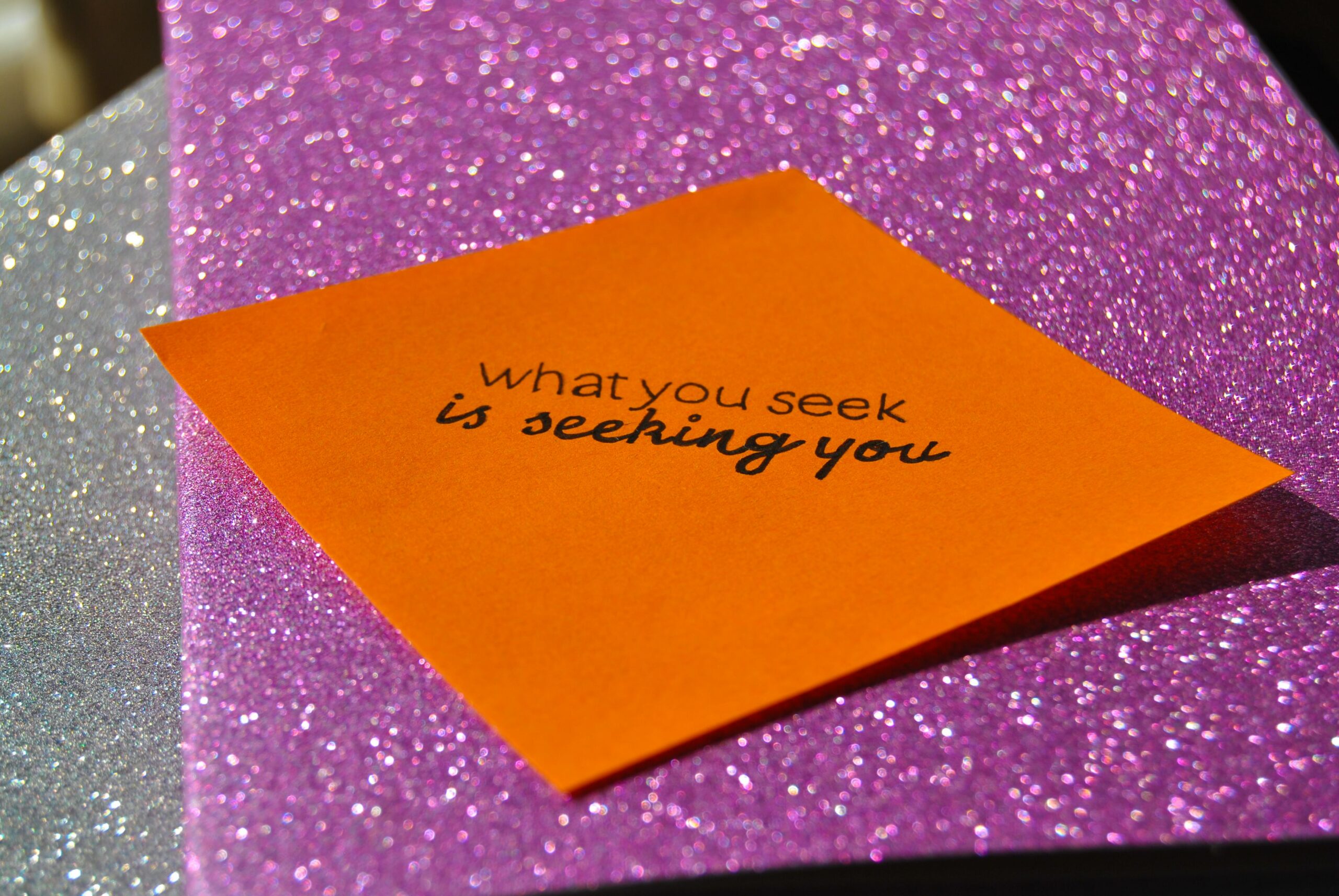 a post-it that says "what you seek is seeking you", used for article manifest a job using law of attraction